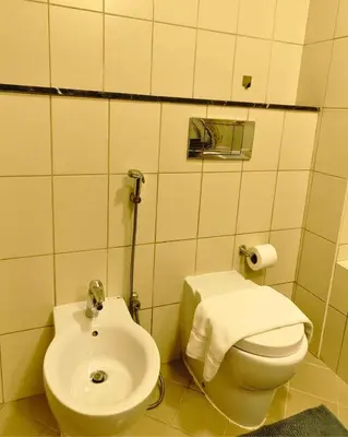 a bathroom with a white toilet and a sink at Charming & Comfortable 1BR Jumeirah Bay X1 JLT in Dubai