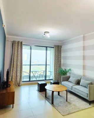 a living room with a couch and a table at Charming & Comfortable 1BR Jumeirah Bay X1 JLT in Dubai