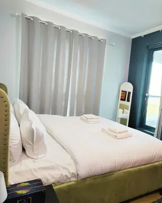a bedroom with a bed with white sheets and a window at Charming & Comfortable 1BR Jumeirah Bay X1 JLT in Dubai