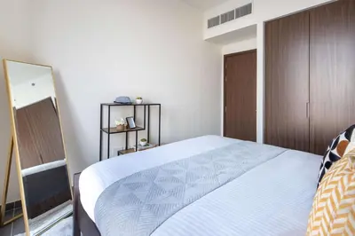 a bedroom with a large bed and a mirror at Frank Porter - Creek Edge Tower 1 in Dubai