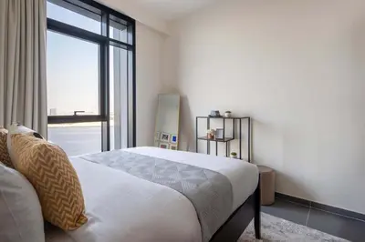 a bedroom with a bed and a large window at Frank Porter - Creek Edge Tower 1 in Dubai