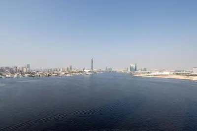 a large body of water with a city in the background at Frank Porter - Creek Edge Tower 1 in Dubai