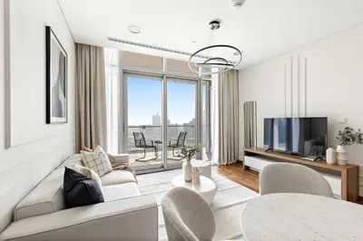 a living room with a couch and a tv at Silkhaus Burj Khalifa & Zaabeel View in Burj Daman in Dubai