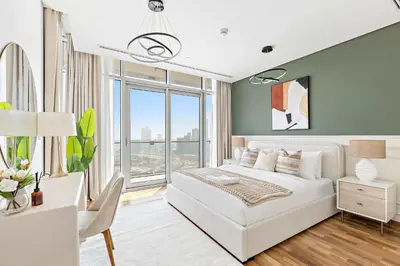 a bedroom with a white bed and a large window at Silkhaus Burj Khalifa & Zaabeel View in Burj Daman in Dubai