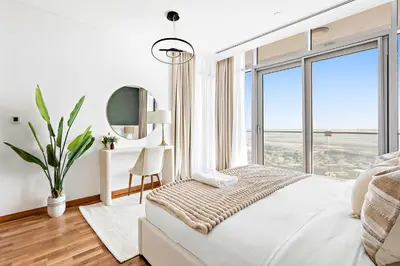 a bedroom with a bed with a large window at Silkhaus Burj Khalifa & Zaabeel View in Burj Daman in Dubai