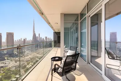 a balcony with two chairs and a view of the city at Silkhaus Burj Khalifa & Zaabeel View in Burj Daman in Dubai