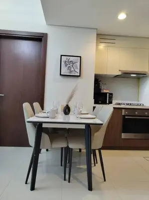 a dining table and chairs in a kitchen at Cozy 2BR Apartment DAMAC VERA Business Bay in Dubai