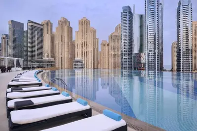 a pool with a view of a city with tall buildings at The Magnificent in Dubai