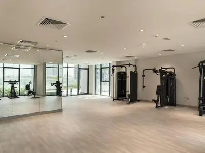a large room with a gym with a large mirror at Newly Furnished Studio Azizi Riviera 37 Al Meydan in Dubai