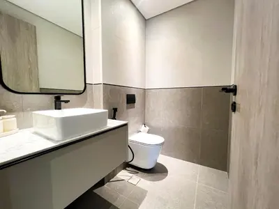 a bathroom with a sink and a toilet at 1-BR Gem with Luxe Amenities in JVC in Dubai
