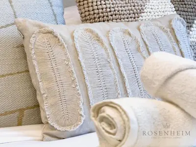 a pile of pillows sitting on a couch at Sparkle Skyline Studio - Contemporary Living in Dubai