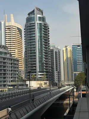 a bridge over a river in a city with tall buildings at Sparkle Skyline Studio - Contemporary Living in Dubai