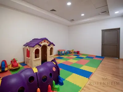 a room with a play room with a toy house at Luxury Canal View Studio at Sparkle Tower in Dubai