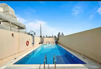 a swimming pool on the roof of a building at Skyline Dream - 1 BHK - Burj and Canal views in Dubai