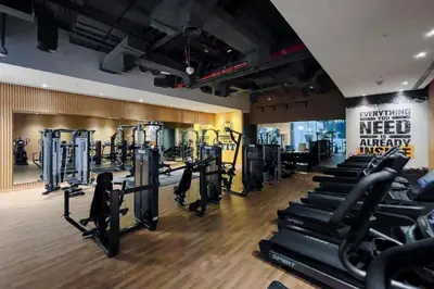 a gym with several rows of treadmills and machines at Seven Palm Residences Palm Jumeirah by Happy Season in Dubai