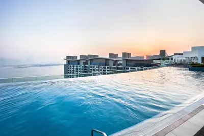 a large swimming pool on the roof of a building at Seven Palm Residences Palm Jumeirah by Happy Season in Dubai