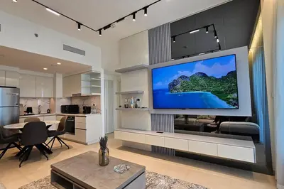 a living room with a large flat screen tv on a wall at Downtown Dubai views 2 tower 1 in Dubai