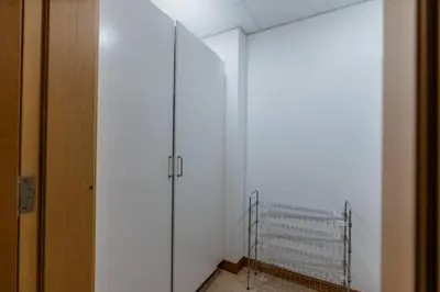 a hallway with a white wall and a metal gate at Elegant 1BR beach access with Ocean Views, Palm in Dubai
