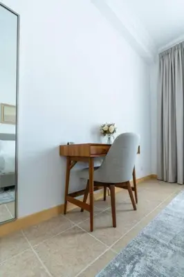 a desk with a chair and a mirror in a room at Elegant 1BR beach access with Ocean Views, Palm in Dubai