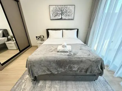 a bedroom with a bed with a towel on it at Sleek & Spacious 1br Jvc Pool View in Dubai