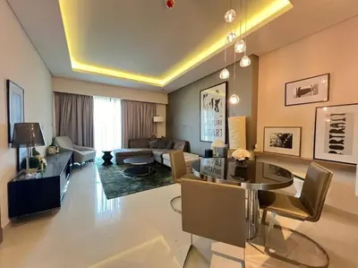 a living room with a couch and a table at Luxurious & Modern 1BR DAMAC Paramount Business Bay in Dubai