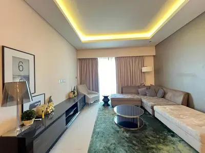 a living room with a couch and a table at Luxurious & Modern 1BR DAMAC Paramount Business Bay in Dubai
