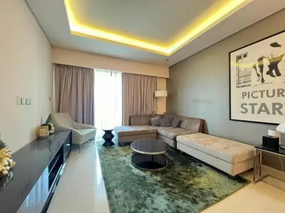 a living room with a couch and a table at Luxurious & Modern 1BR DAMAC Paramount Business Bay in Dubai