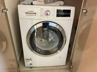 a washer and dryer in a room at Luxurious & Modern 1BR DAMAC Paramount Business Bay in Dubai
