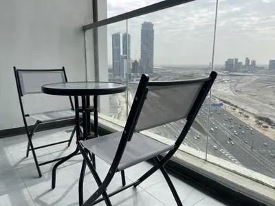 a table and chair in a room with a window at Modern Studio in Business Bay in Dubai