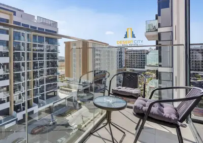 a balcony with chairs and a table on a building at Fully Furnished One Bed in Meydan, Hosted by Desert City Stays in Dubai