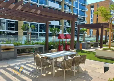 a patio with a table and chairs in a building at Fully Furnished One Bed in Meydan, Hosted by Desert City Stays in Dubai