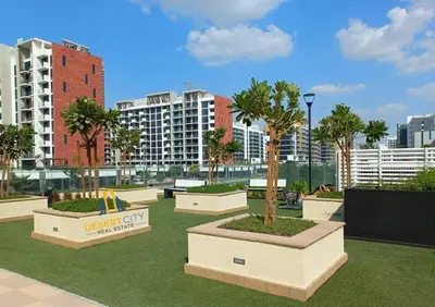 a rendering of a park with palm trees and buildings at Fully Furnished One Bed in Meydan, Hosted by Desert City Stays in Dubai