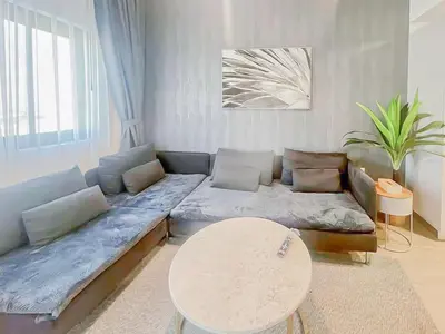 a living room with a couch and a table at Luxury 2 Bedroom in the Nook 1 next to Metro Energy in Dubai