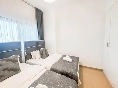 a hotel room with two beds and a window at Luxury 2 Bedroom in the Nook 1 next to Metro Energy in Dubai