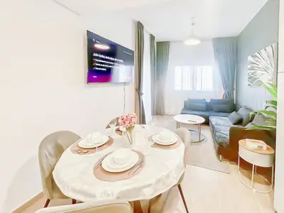a living room with a white table and chairs at Luxury 2 Bedroom in the Nook 1 next to Metro Energy in Dubai