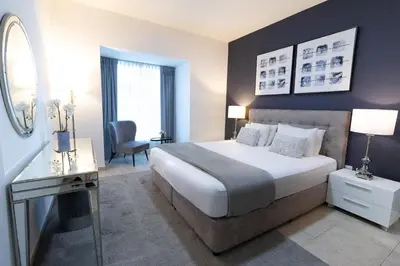 a bedroom with a bed and a desk and a chair at Elite Residences Tower Dubai Marina by Happy Season in Dubai