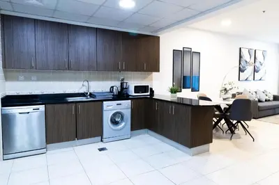 a kitchen with a washer and a sink and a dishwasher at Elite Residences Tower Dubai Marina by Happy Season in Dubai