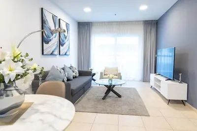 a living room with a couch and a table at Elite Residences Tower Dubai Marina by Happy Season in Dubai