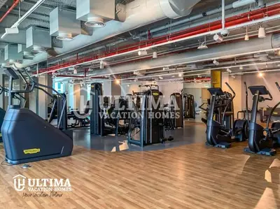 a gym with treadmills and elliptical machines at Elegant 2BR Burj Khalifa view-Downtown Views II in Dubai