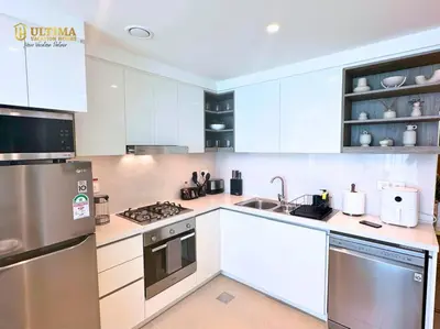 a kitchen with white cabinets and stainless steel appliances at Elegant 2BR Burj Khalifa view-Downtown Views II in Dubai