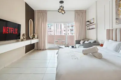 a hotel room with a bed and a tv at Urban Designer Apt - Family Friendly in Dubai