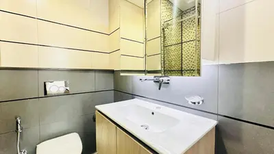 a bathroom with a sink and a toilet at Premium 1-Bedroom Perla Apartment in JVC | Infinity Pool & Kids’ Play Area in Abu Dhabi