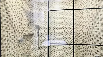 a shower with a glass door in a bathroom at Premium 1-Bedroom Perla Apartment in JVC | Infinity Pool & Kids’ Play Area in Abu Dhabi
