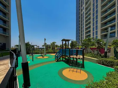 an empty playground with a slide in a park at Frank Porter - Aykon City Tower C in Dubai