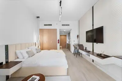 a bedroom with a large bed and a flat screen tv at Studio Azizi Riviera 24 Community View in Dubai