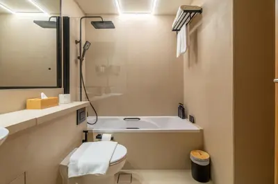 a bathroom with a tub and a toilet and a sink at Boho Nordic Bliss in Dubai in Dubai