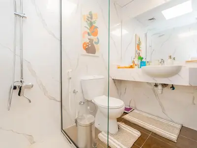 a bathroom with a toilet and a sink at Serene 1BR in Diamond Views 3 JVC - Pool Access & Peaceful Living , Managed by Think Realty in Dubai