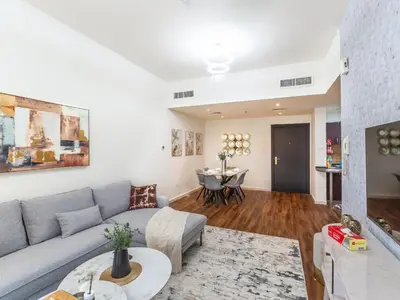 a living room with a couch and a table at Serene 1BR in Diamond Views 3 JVC - Pool Access & Peaceful Living , Managed by Think Realty in Dubai