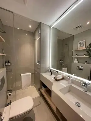 a bathroom with a toilet and a sink and a mirror at Luxury Studio apartment in JVC, Oakley Square Residences in Dubai