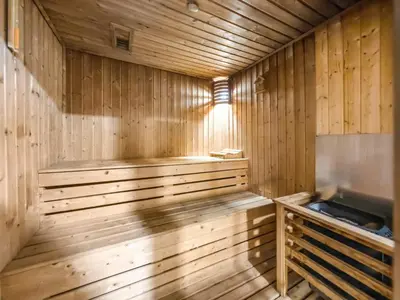 a wooden sauna with a bench in the middle at Spacious Home Near Metro & Beach in Dubai Marina in Dubai